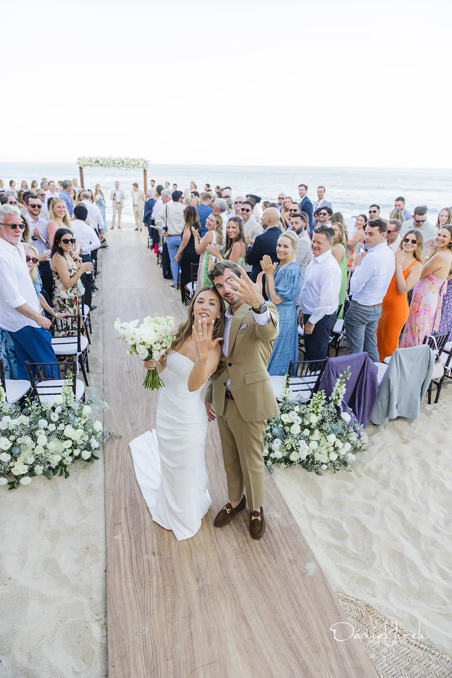 Beach ceremony aisle with guests