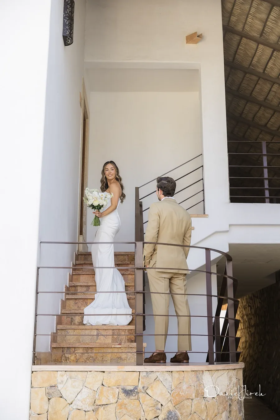 Couple on staircase overlooking the ocean